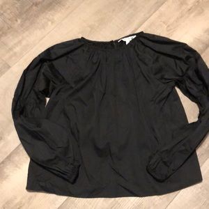 An adorable size Small women’s black long sleeve shirt.